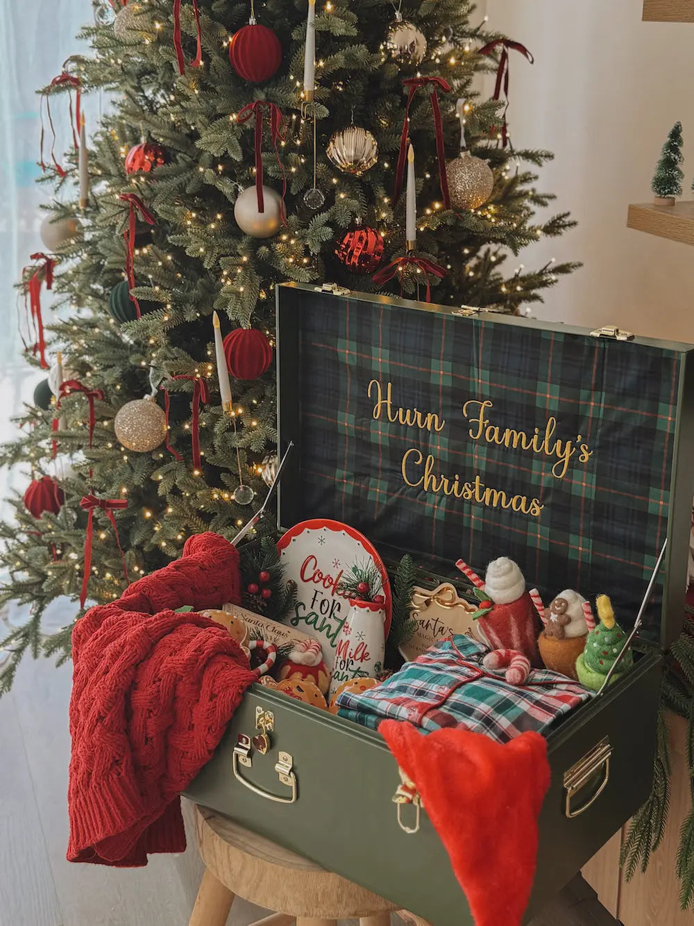 Decorated Christmas tree with a suitcase labeled &