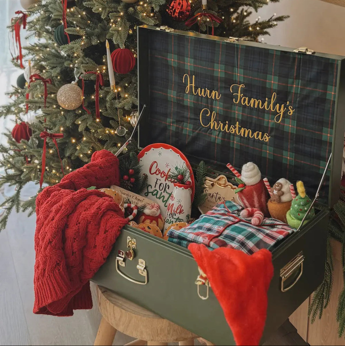 Decorated Christmas tree with a suitcase labeled &