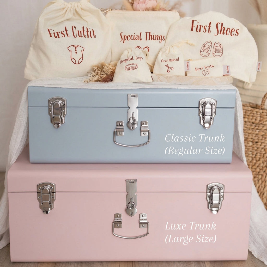 Two trunks, one blue and one pink, with baby items and bags on a light background.
