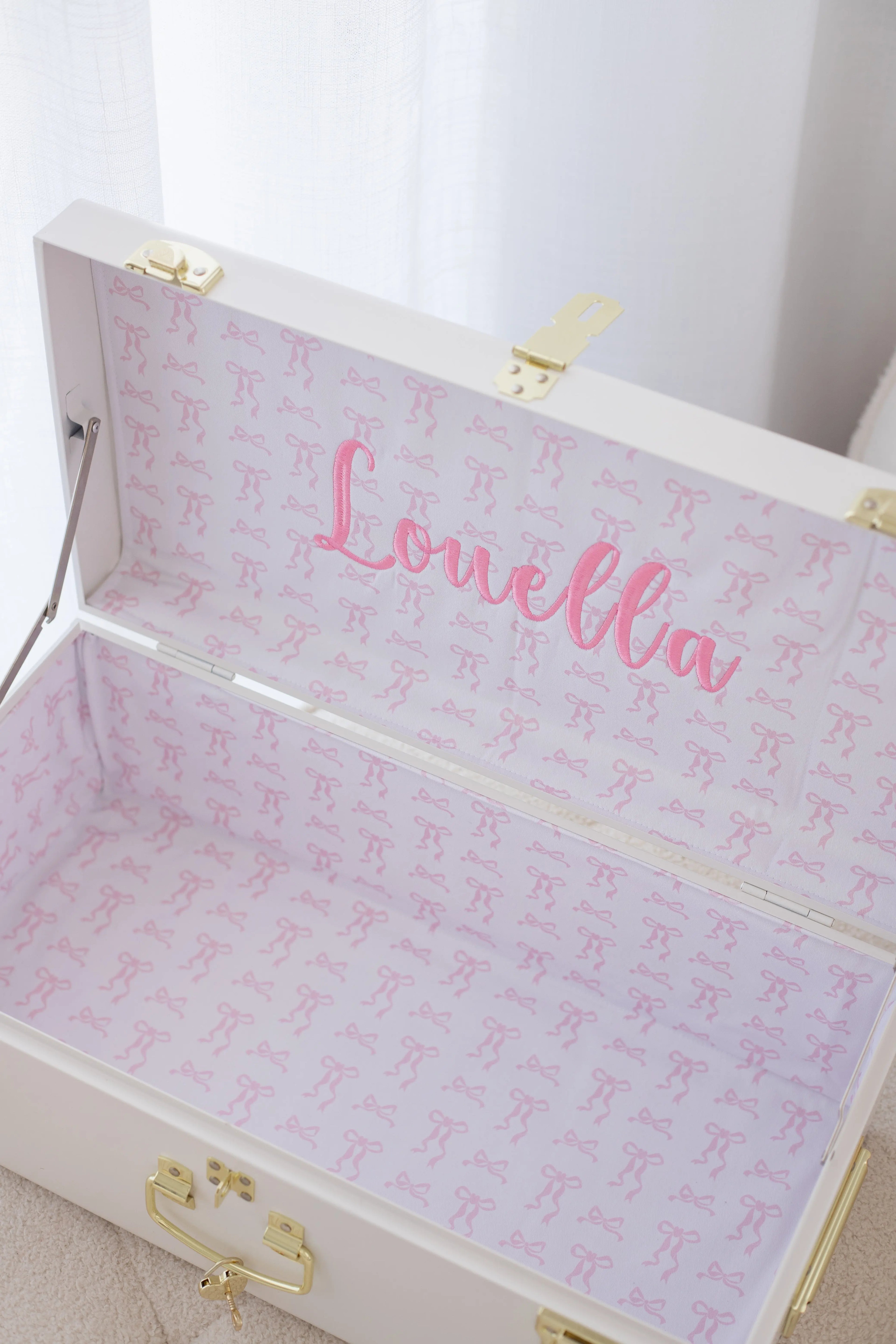 White jewelry box with pink interior and &