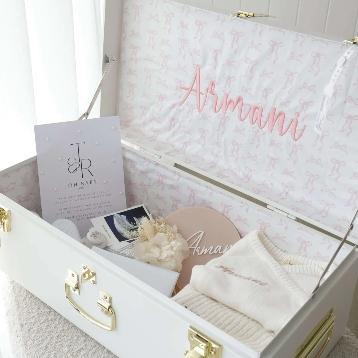 White trunk with gold accents labeled &